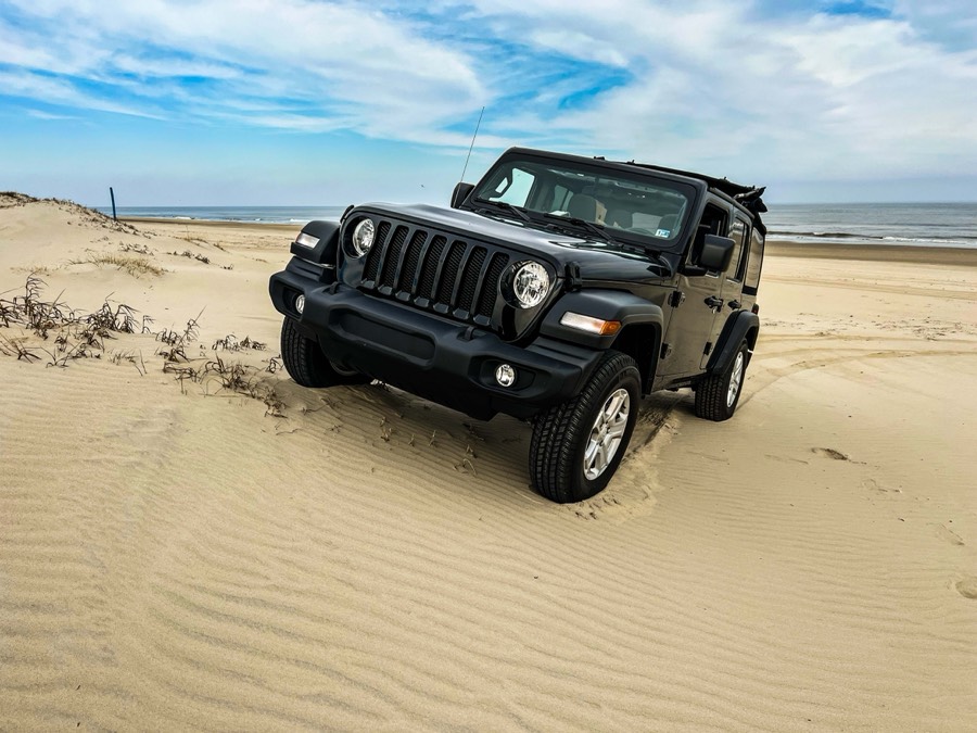 4x4 SUV beach rental climbing dunes, Outer Banks